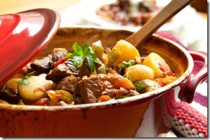 Traditional goulash or beef stew, in red crock pot, ready to serve.  Shallow DOF.