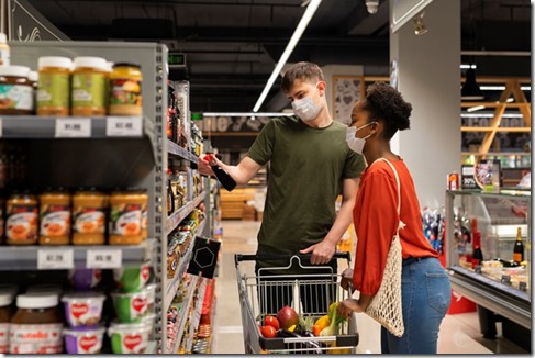 man-and-woman-with-medical-masks-out-grocery-shopping-with-shopping-cart